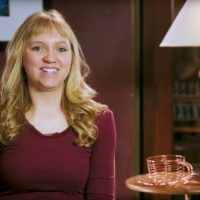 Jenna Albrecht sitting in chair smiling at camera