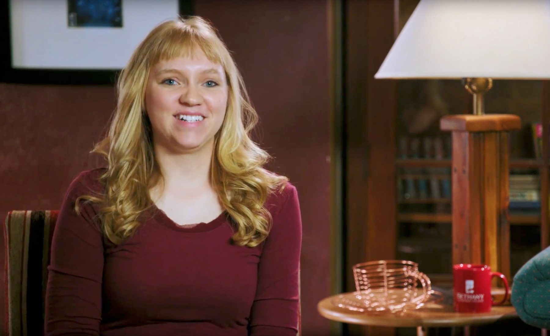 Jenna Albrecht sitting in chair smiling at camera