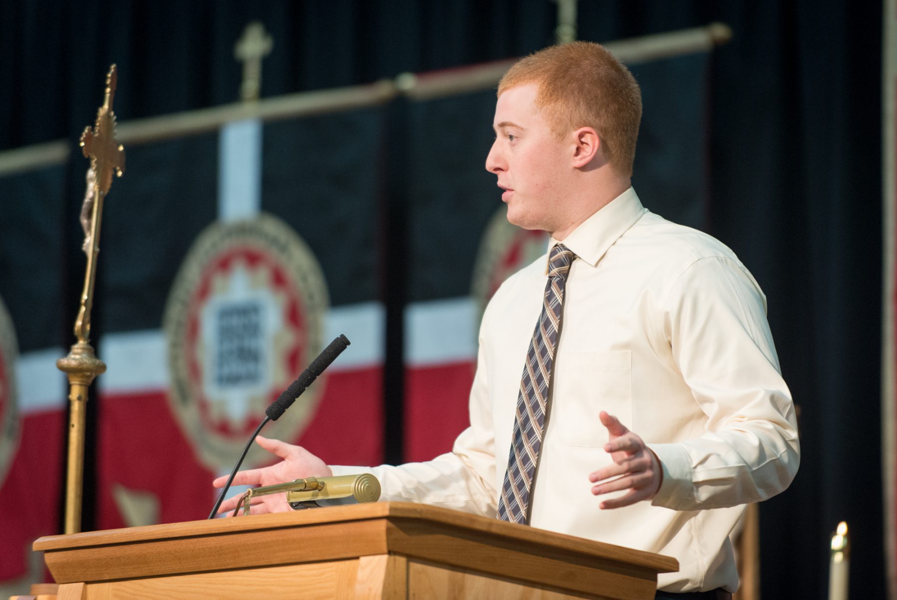 Jacob Schneider speaking from a podium