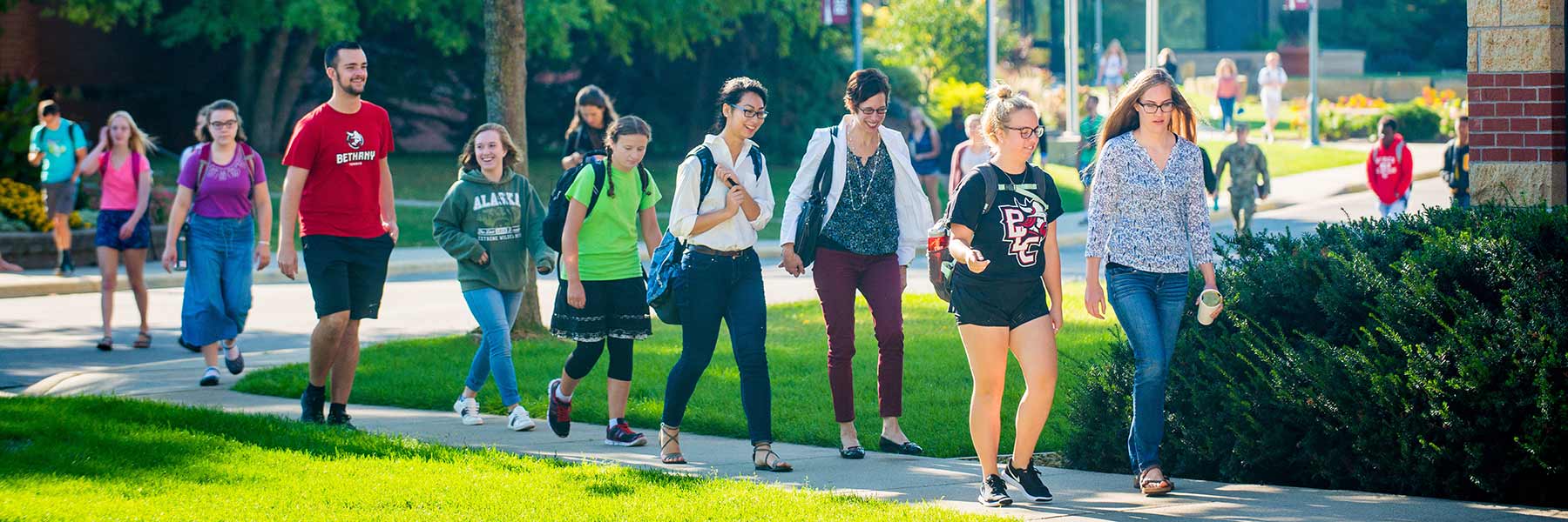 Students walking to chapel on a sunny day