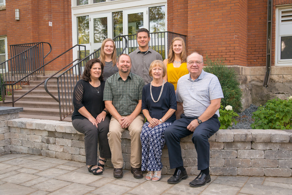 The Strom Family in front of the Old Main entrance with three generations represented.