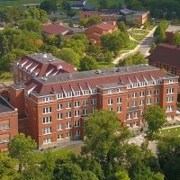 Aerial View of campus from valley in front of Old Main looking back towards Marsh & Division Streets