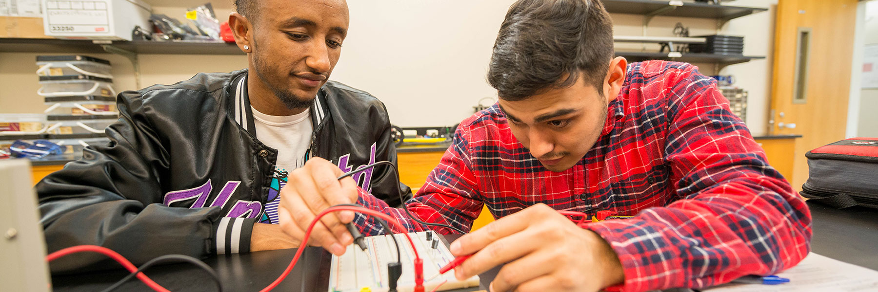 two students working on an electricity project