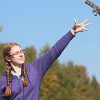 Abigail Merritt releasing a Sharp-shinned Hawk