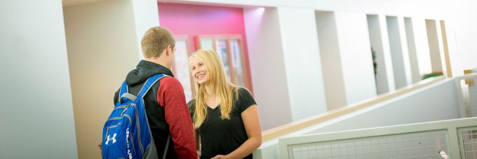 Two students talking in Honsey hall