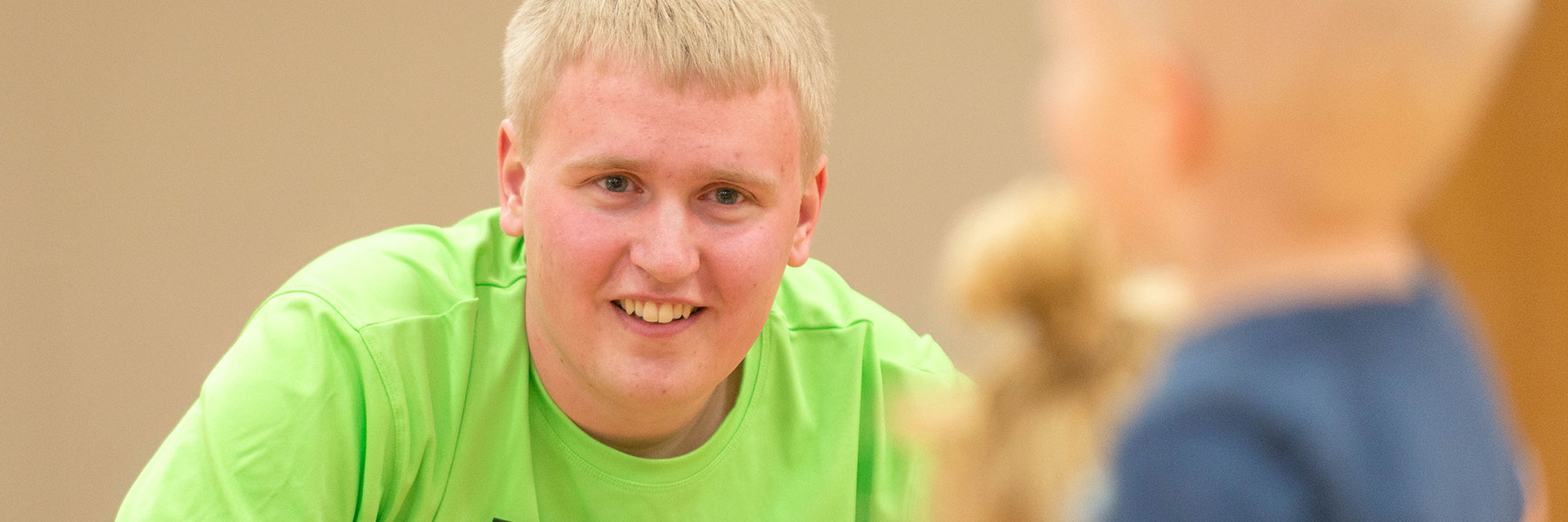 male student in bright green shirt