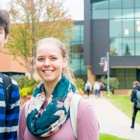 Two students pose for photo in front of Honsey Hall