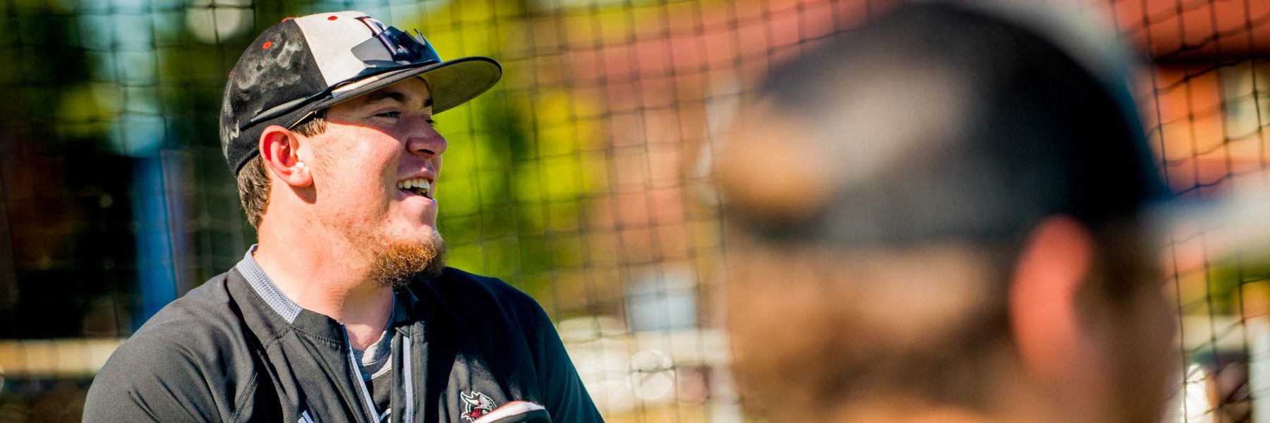 Baseball players share a laugh during warm ups before a practice