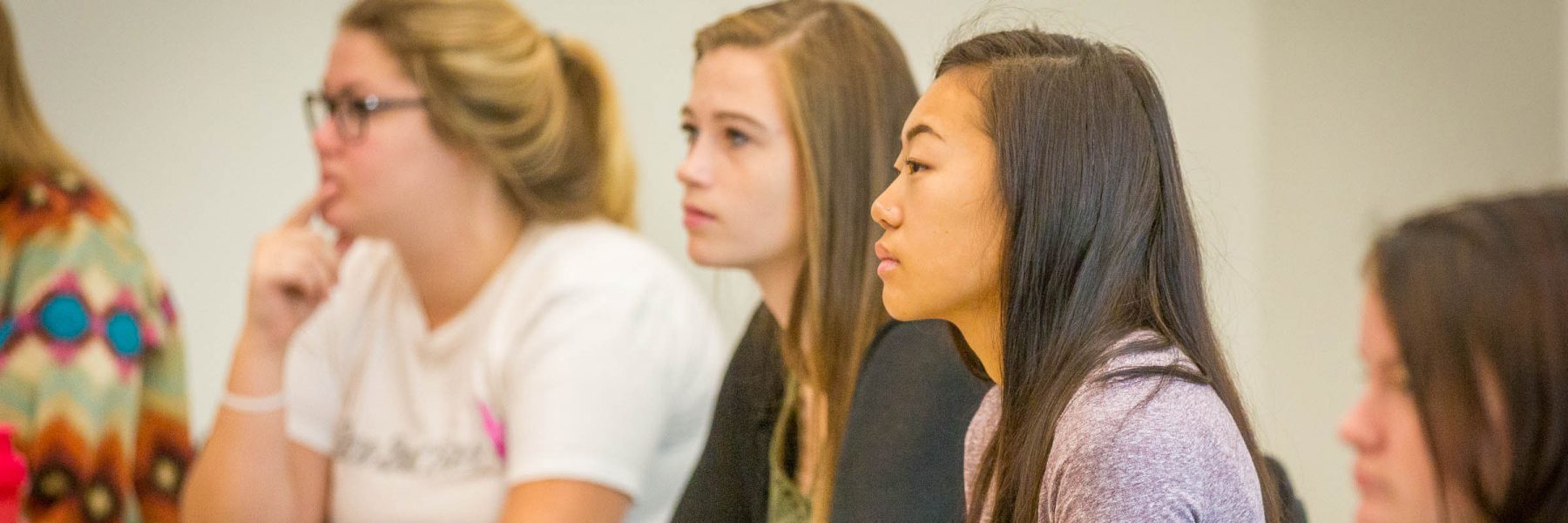 female students listening in classroom