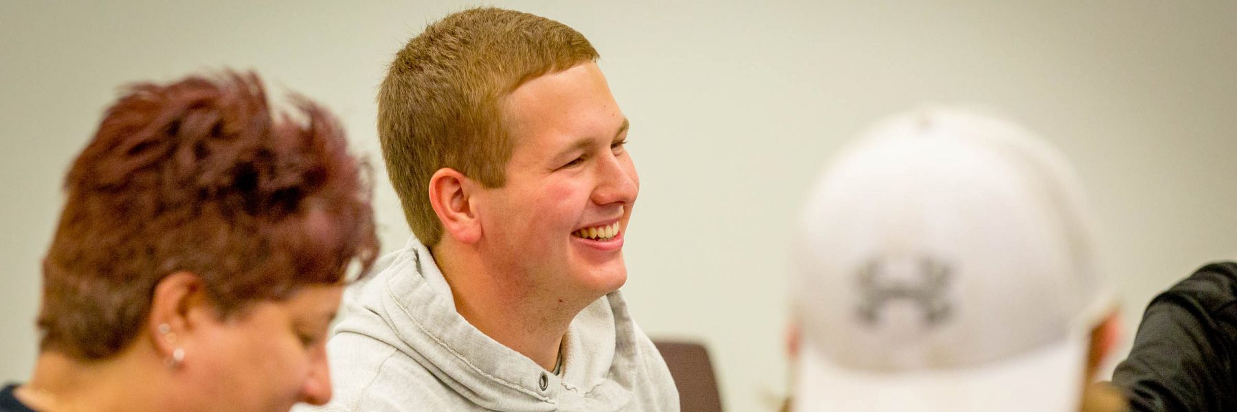 Male student smiling in class