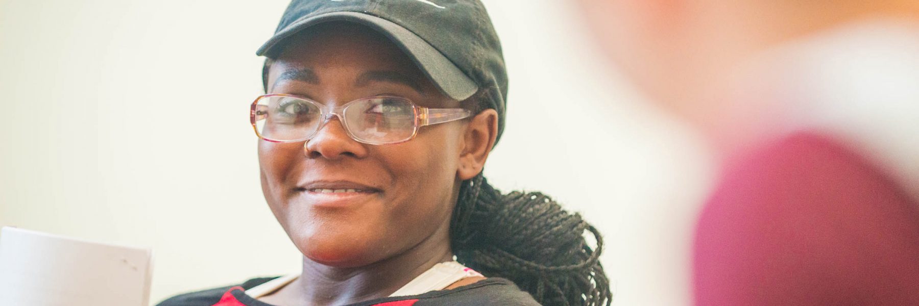 Female student smiling in Honsey Hall lounge