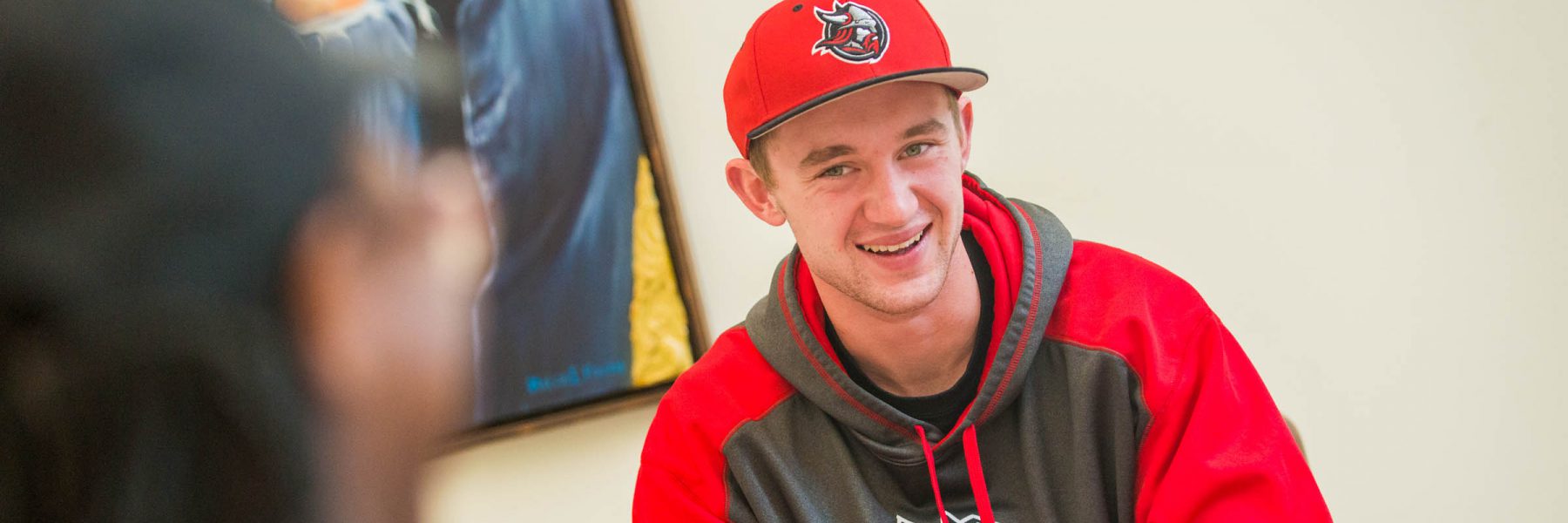 Male student smiling in Honsey Hall lounge