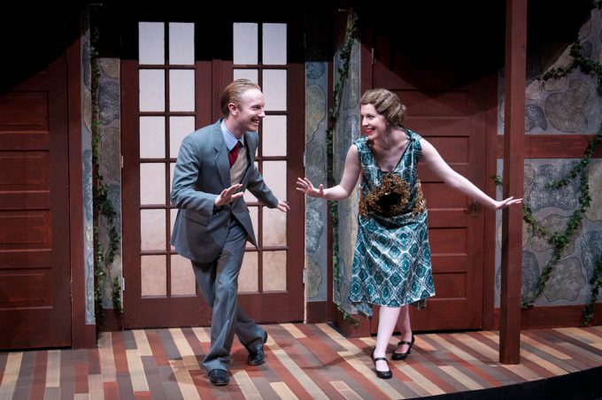 Man and woman on stage dancing - 20s style. Man in 3 piece suit, woman in dress and pin curls (from 20s)