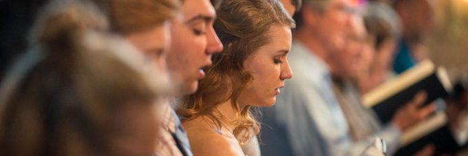 students singing in chapel