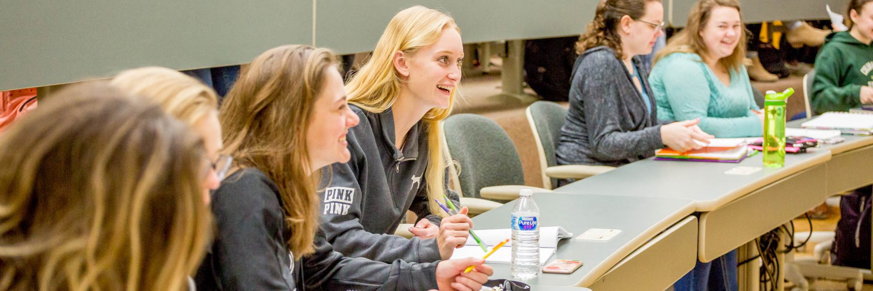 Group of students in class, smiling and laughing