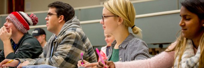 Students in a class, taking notes