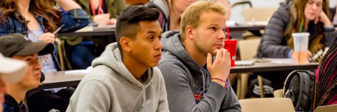 Students in class, listening to speaker