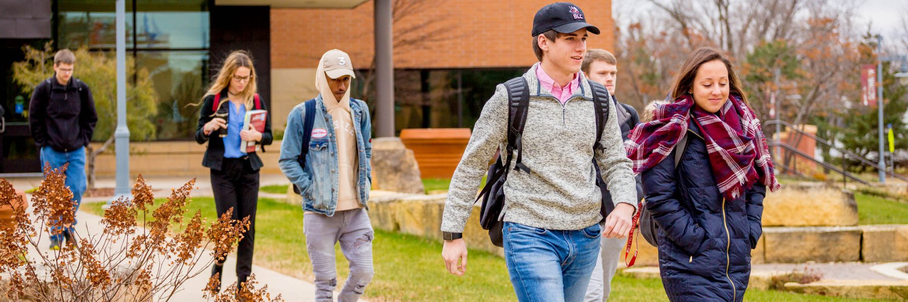 Group of students walking out of Honsey Hall and down sidewalk