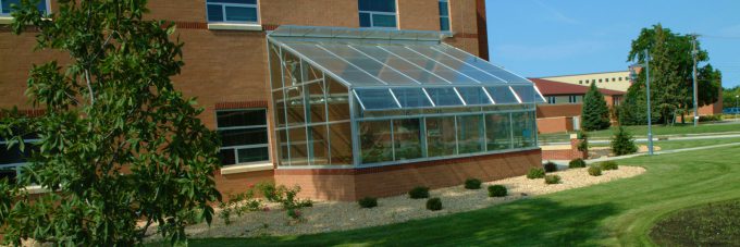 Greenhouse on side of Meyer Hall on a sunny summer day