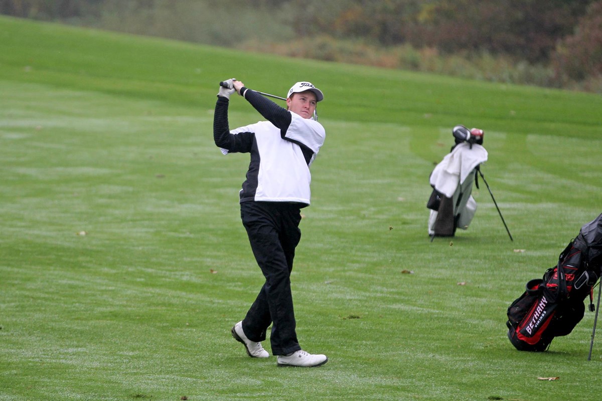 Men's golfer with club over shoulder after a swing