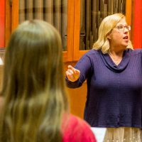 Ann Frederickson, a professor in the BLC Music Department, directs the Mary Martha Singers choir during a practice.