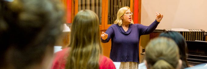 Ann Frederickson, a professor in the BLC Music Department, directs the Mary Martha Singers choir during a practice.