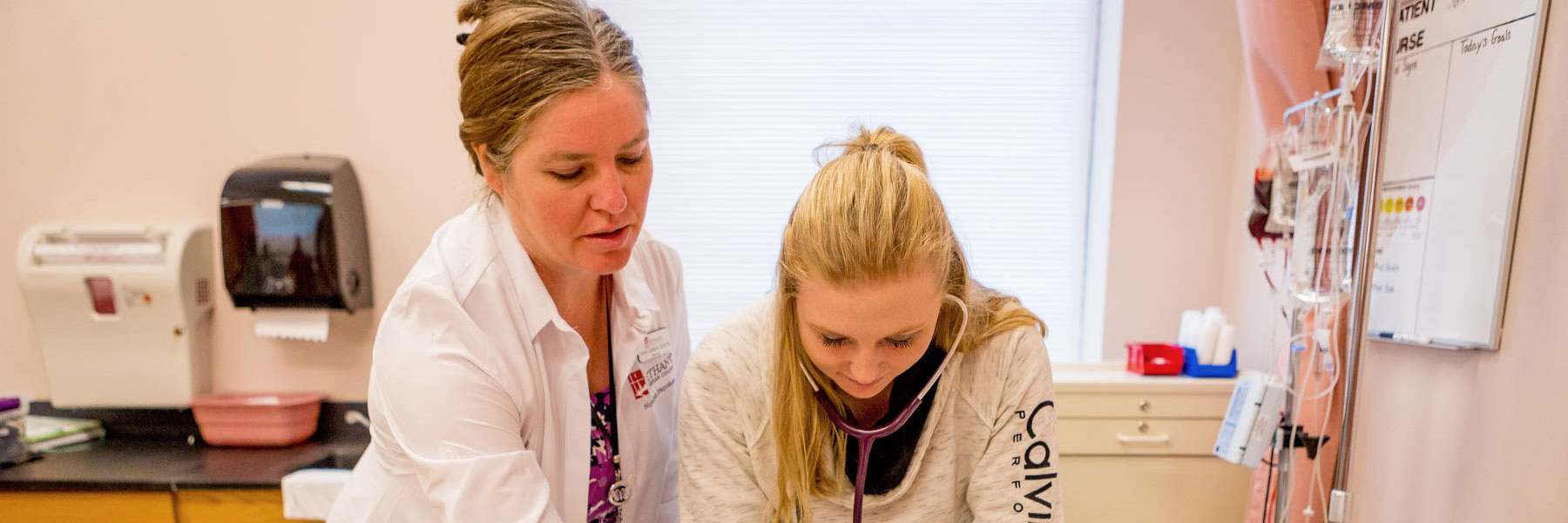 Cheryl Clendenin works with a student in the Bethany Lutheran College nursing lab.