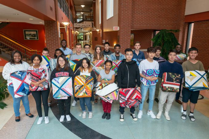 International students with their hand-made quilts.