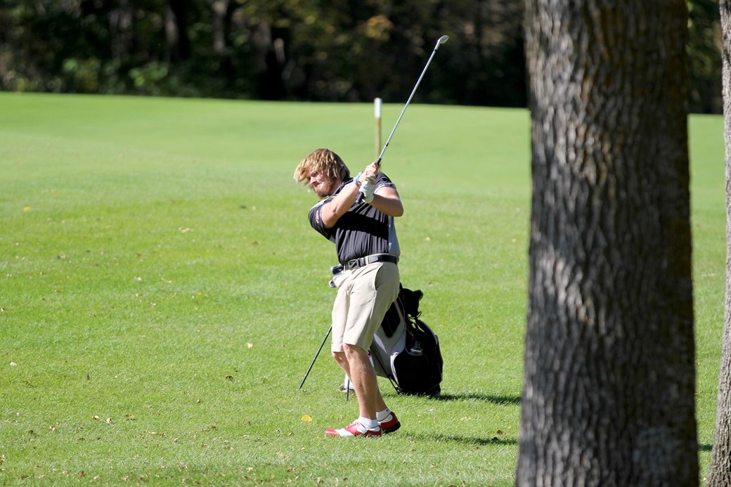 Men's golfer hits ball on fairway