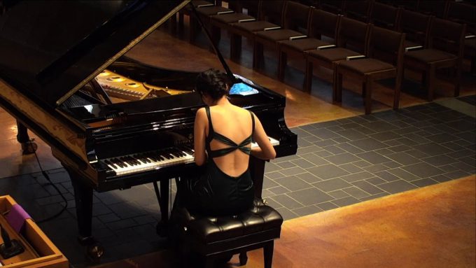 Student Sarah Wei plays a grand piano in Trinity Chapel during her Junior Piano Recital.