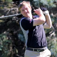 A Bethany Vikings Men's Golf player takes a swing on the course.