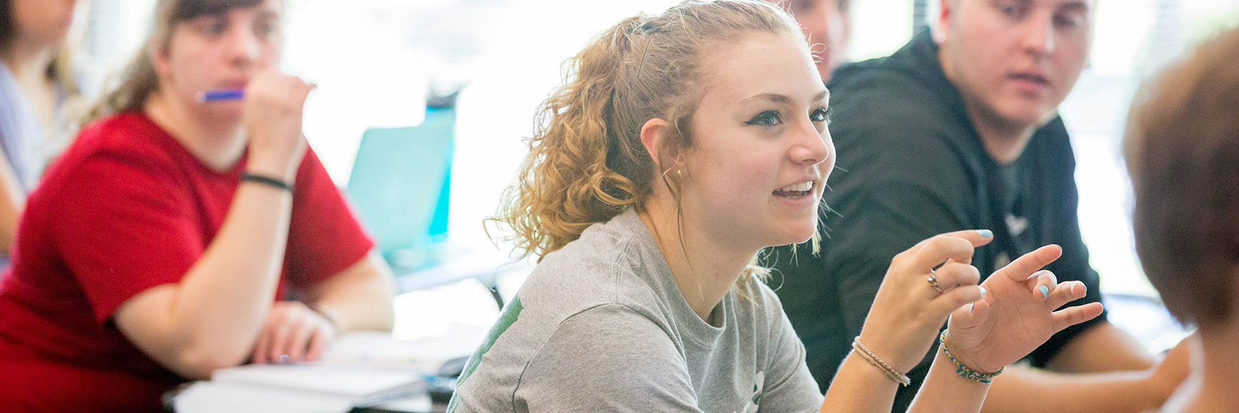 female student talking during a class discussion