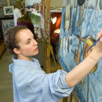 Lussky paints in the art studio.