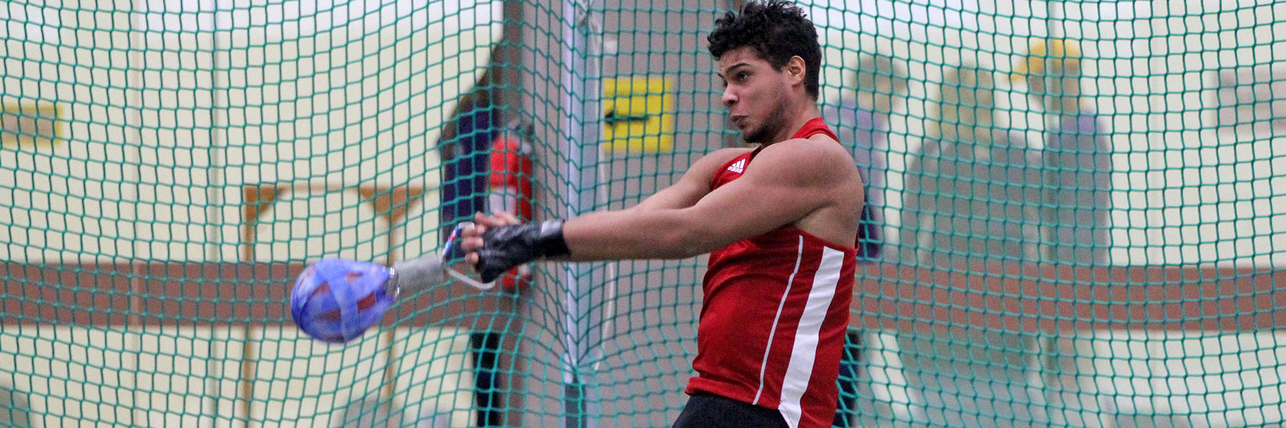 A student participates in a hammer throw during a track and field meet.