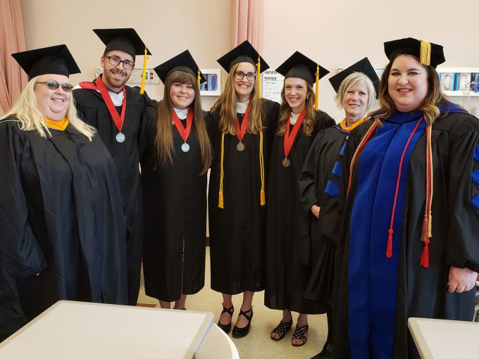 Bethany 2019 nursing graduates and professors in gowns.