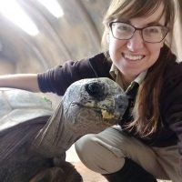 Photo of Rebecca Jahns and a large tortoise