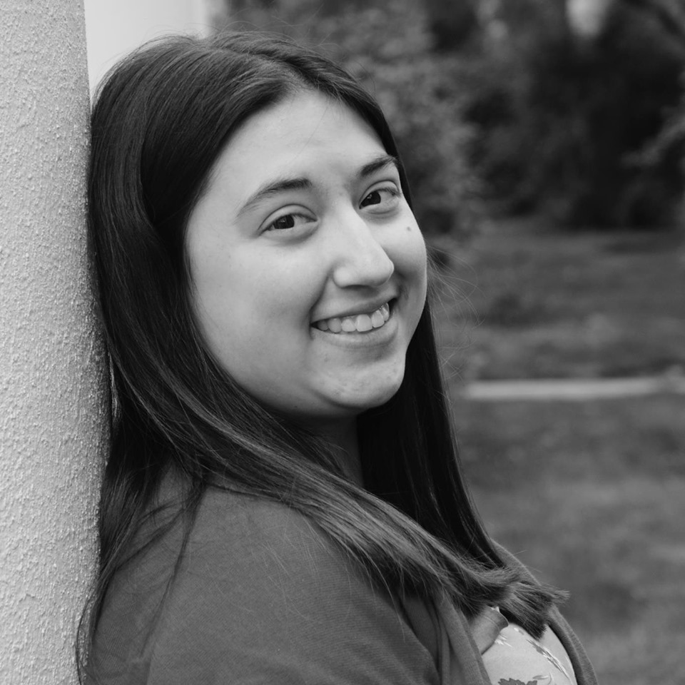 Photo of Gabrielle Emmmons standing against a wall