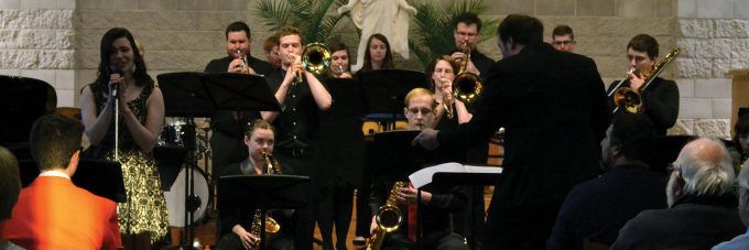 soloist sings while jazz band plays behind her in the chapel