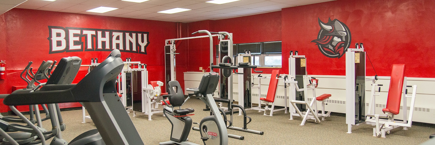 exercise equipment in a room with red walls