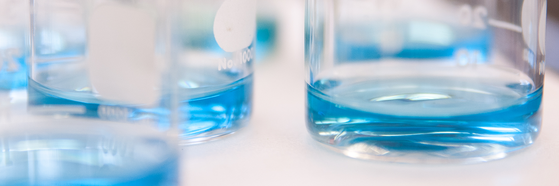 Chemistry beakers filled with blue liquid