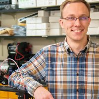 Student Daniel Halvorson smiling in physics lab