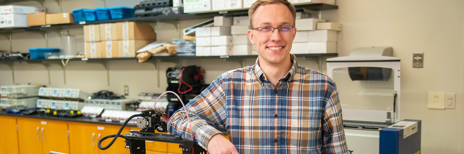 Student Daniel Halvorson smiling in physics lab