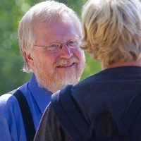 Photo of Mark DeGarmeaux talking with student