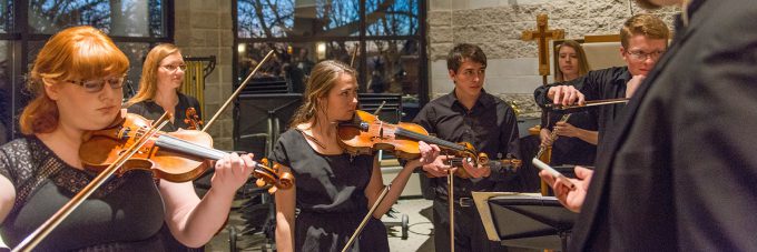 Music performers warm up before a concert with their instruments