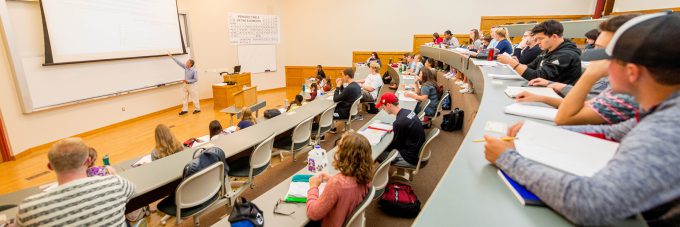 Professor Doyle Holbird teaching in large classroom of meyer hall.