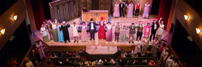 Theatre actors take a bow onstage after a production