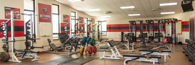 weight room with weights and benches for working out