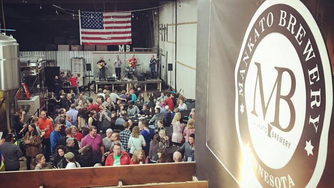 Photo at Mankato Brewery with people and musicians.