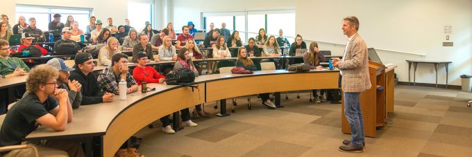 "Meet a German" Day speaker Max Gruenig, President of Ecologic Institute US speaks with students in a classroom.