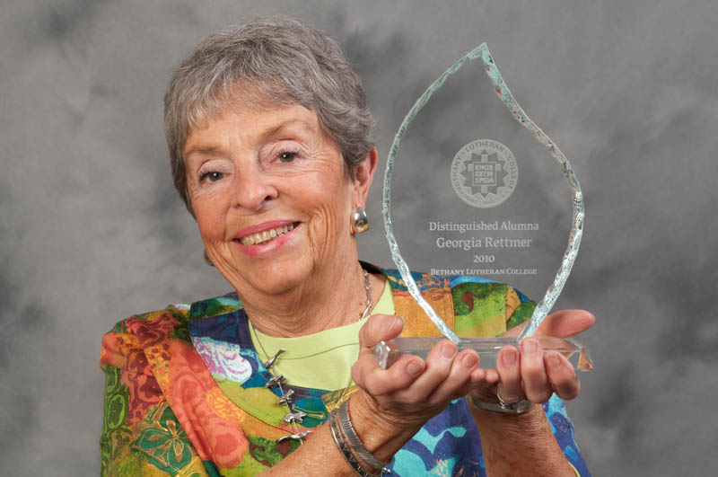 Georgia Rettmer holding the Distinguished Alumna award in 2010.